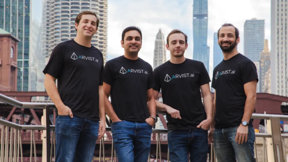 Four Arvist team members together with the Chicago skyline behind them.